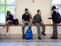 Teenage students socializing in a school hallway