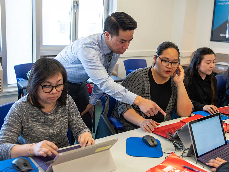 adult students in a class with a teacher